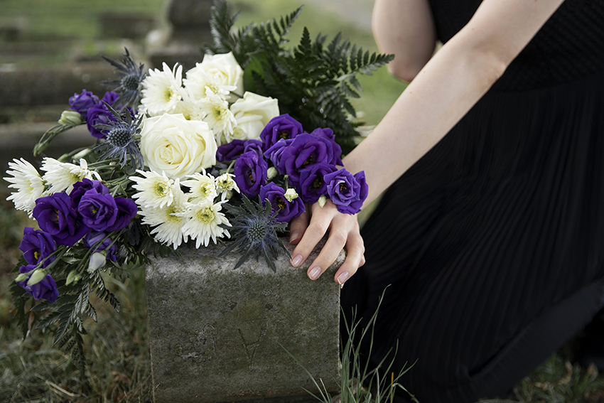 Purple and white in a bouquet on a grave